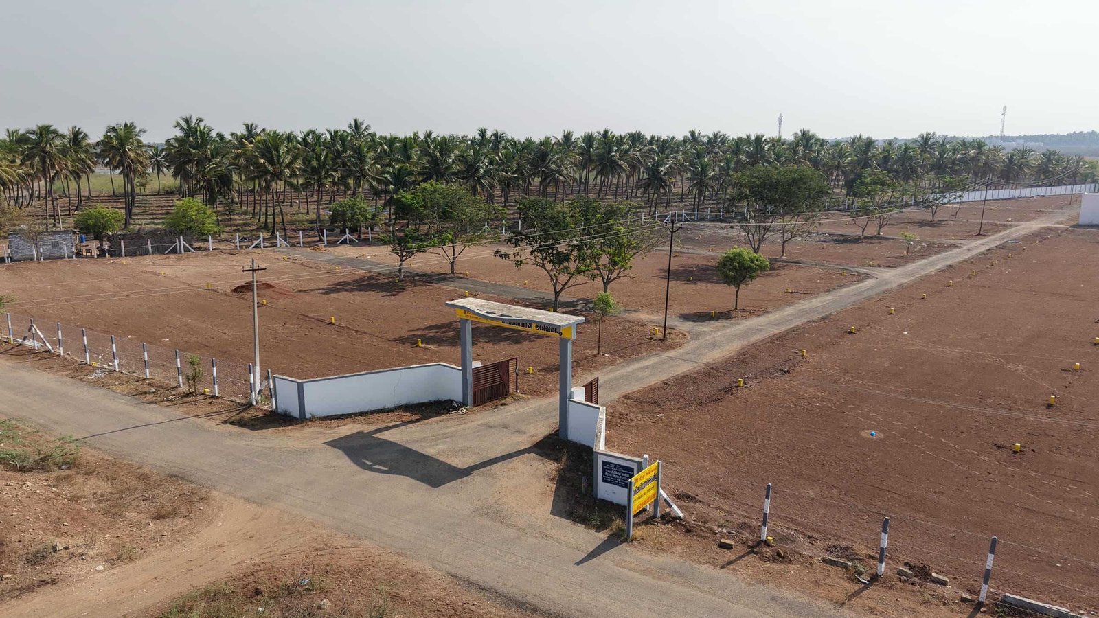 Aerial view of land plots with internal roads and trees